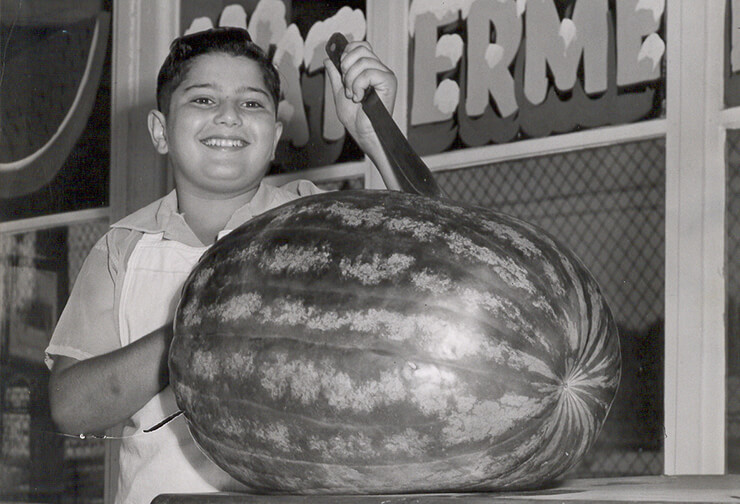 Boy with giant watermelon at Capital City Fruit